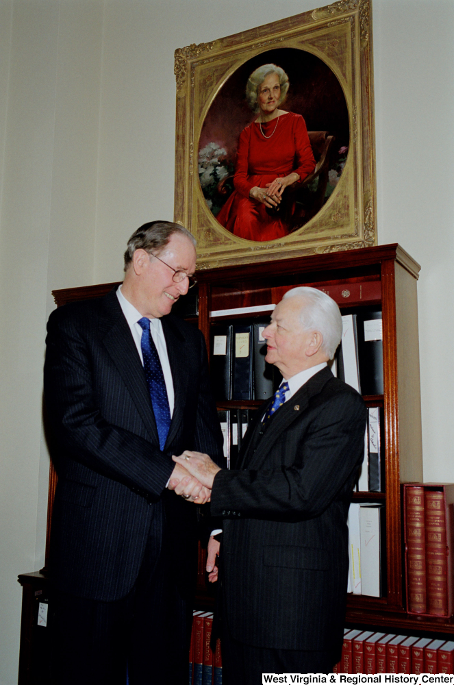["After being sworn into his fourth term, Senator John D. (Jay) Rockefeller shakes hands with Senator Robert C. Byrd."]%