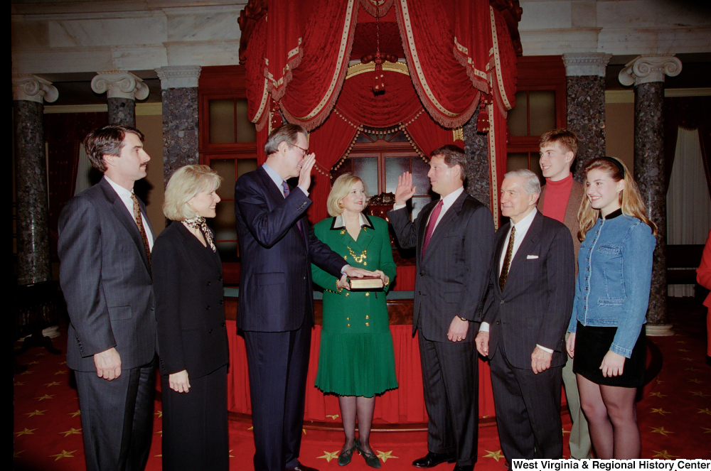 ["Surrounded by his family, Senator John D. (Jay) Rockefeller is sworn into his third term by Vice President Al Gore."]%