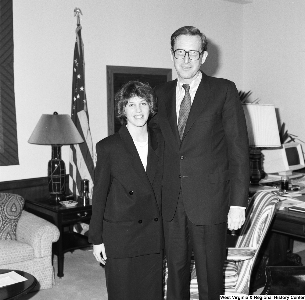 ["Senator John D. (Jay) Rockefeller stands for a photograph with an unidentified woman in his office."]%