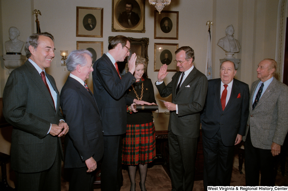 ["This photo shows Vice President George H. W. Bush administering the oath of office to Senator John D. (Jay) Rockefeller. The Senator's wife, Sharon Rockefeller, holds the Bible."]%