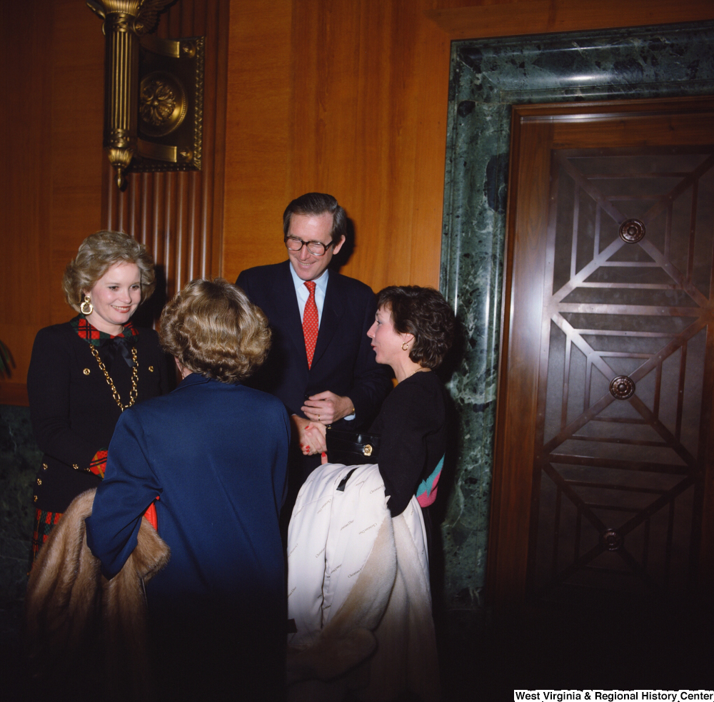 ["Senator John D. (Jay) Rockefeller and wife Sharon greet unidentified individuals following the Senate Swearing-In Ceremony."]%