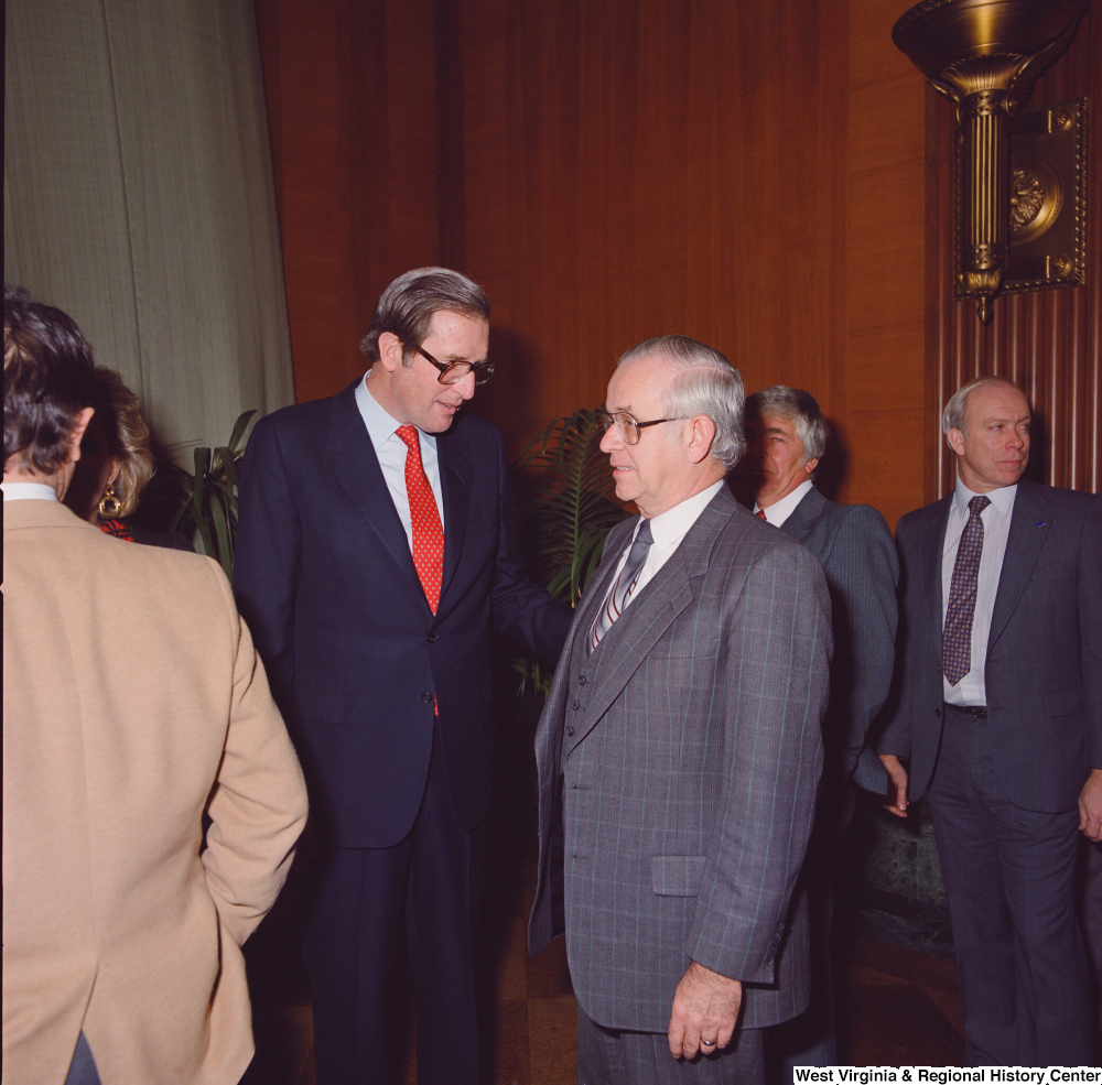 ["An unidentified supporter speaks with Senator John D. (Jay) Rockefeller after the Senate Swearing-In Ceremony."]%