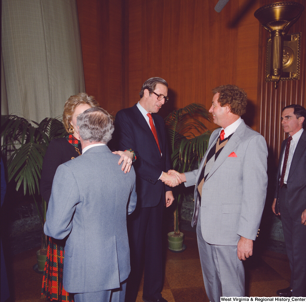 ["Senator John D. (Jay) Rockefeller and Sharon Rockefeller shake hands with unidentified supporters after the Senate Swearing-In Ceremony."]%