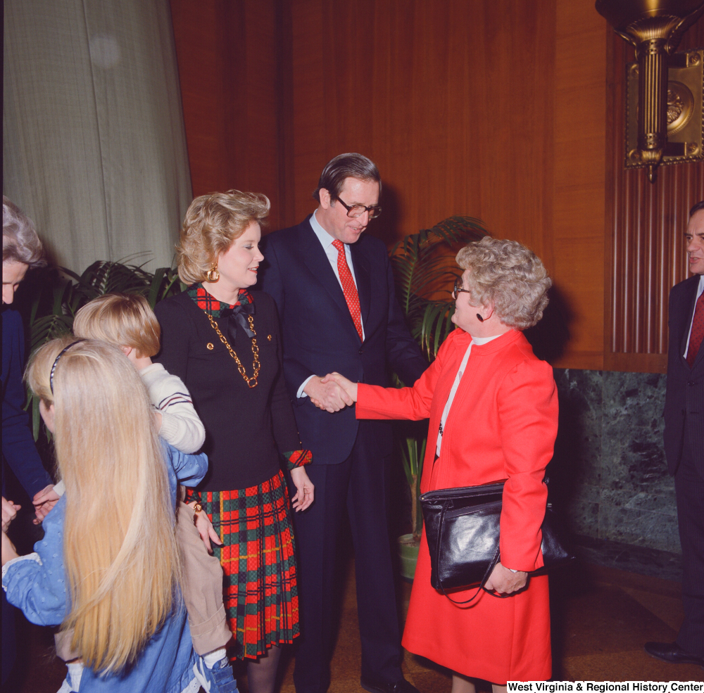 ["After his swearing-in, Senator John D. (Jay) Rockefeller shakes hands with an unidentified supporter."]%