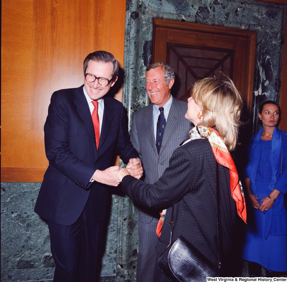 ["Senator John D. (Jay) Rockefeller laughs with unidentified supporters at the Senate Swearing-In Ceremony."]%