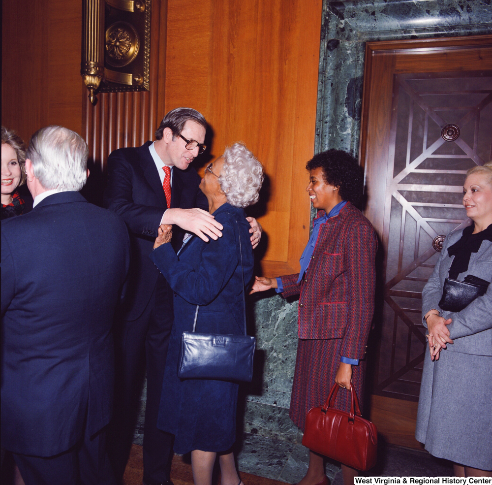 ["Senator John D. (Jay) Rockefeller hugs an unidentified supporter at the Senate Swearing-In Ceremony."]%