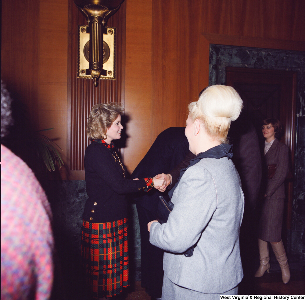 ["Sharon Rockefeller shakes hands with supporters at her husband's Senate Swearing-In Ceremony."]%