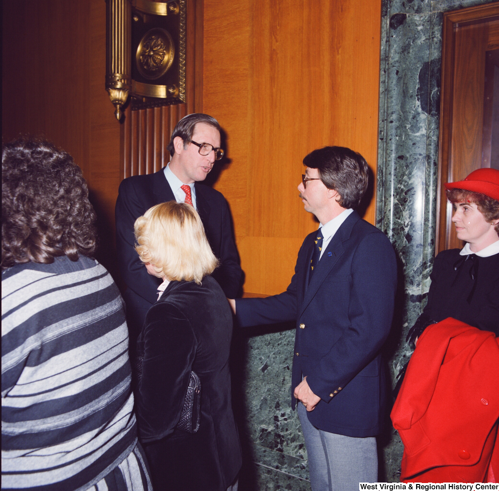 ["After being sworn into office, Senator John D. (Jay) Rockefeller greets unidentified supporters."]%