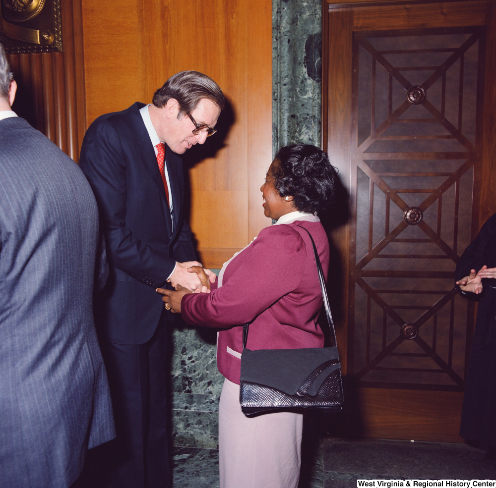 ["An unidentified supporter shakes hands with Senator John D. (Jay) Rockefeller after he is sworn into office at the Senate Swearing-In Ceremony."]%