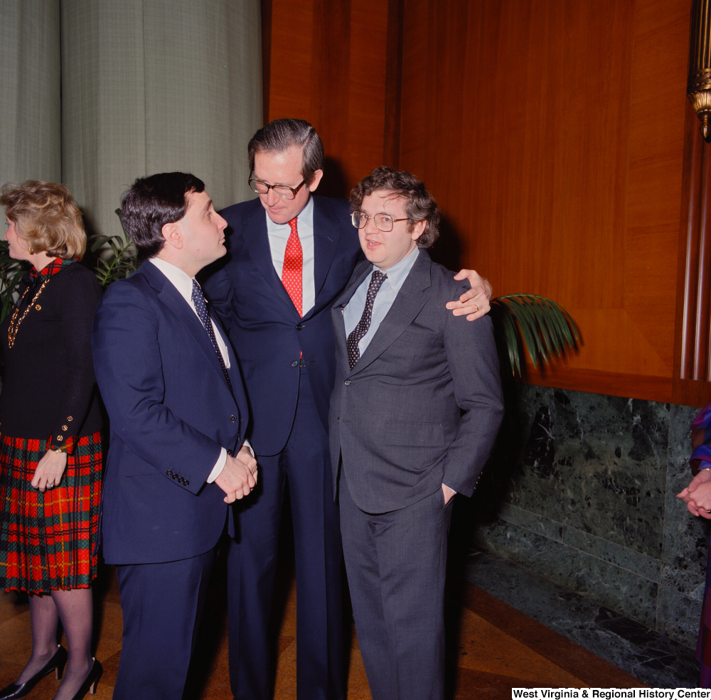 ["Senator John D. (Jay) Rockefeller embraces two unidentified supporters after being sworn into office."]%