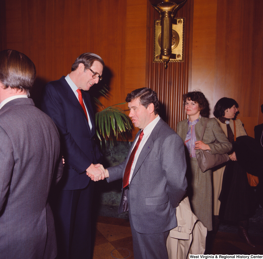 ["Senator John D. (Jay) Rockefeller greets and shakes hands with an unidentified supporter at the Senate Swearing-In Ceremony."]%