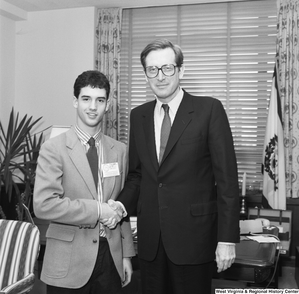 ["Senator John D. (Jay) Rockefeller shakes hands with a participant in A Presidential Classroom for Young Americans. This program aims to give young people an intimate civic-learning experience with the federal government."]%