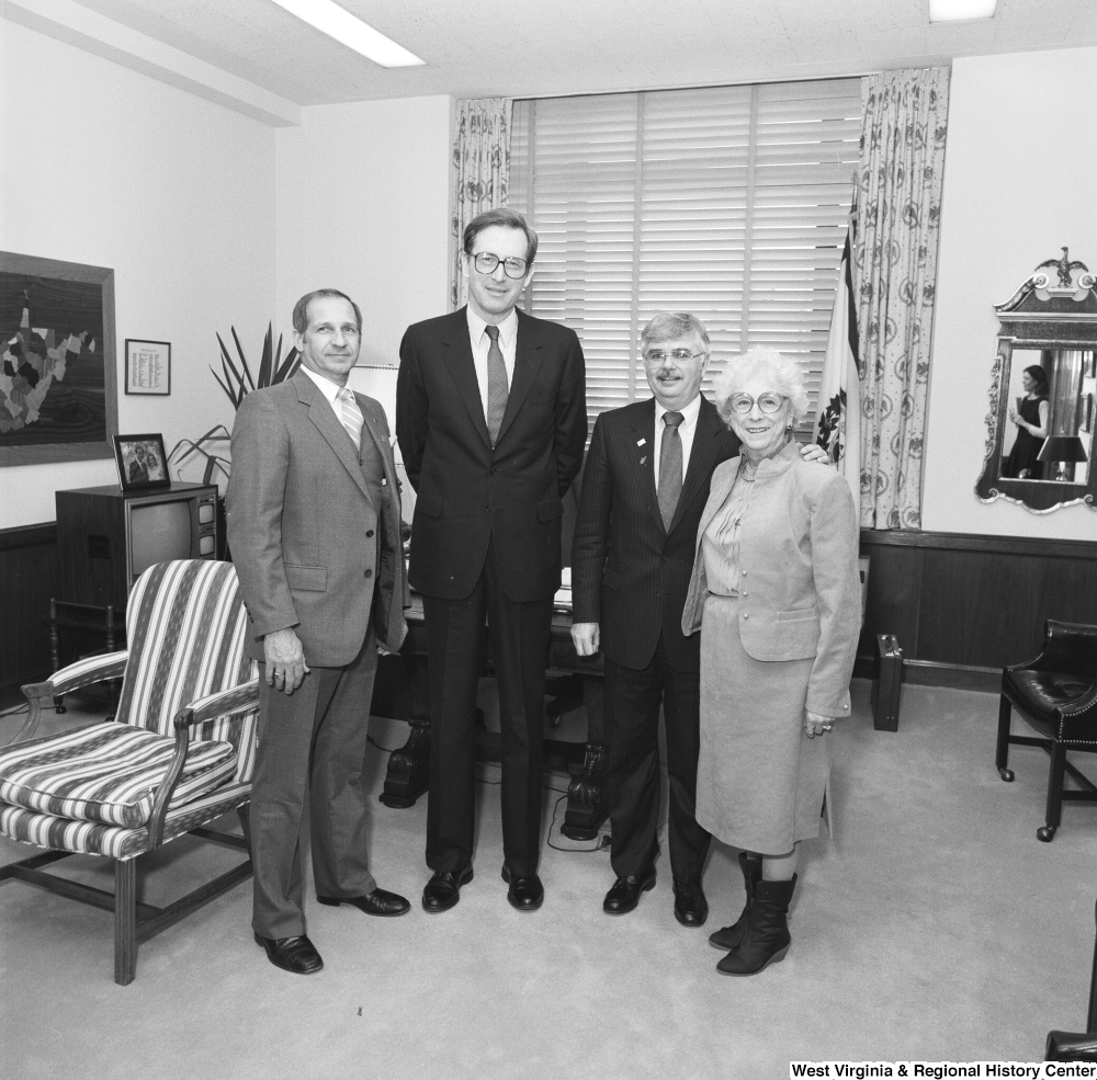 ["Senator John D. (Jay) Rockefeller stands in his office with three representatives from the Education School Budget Group."]%