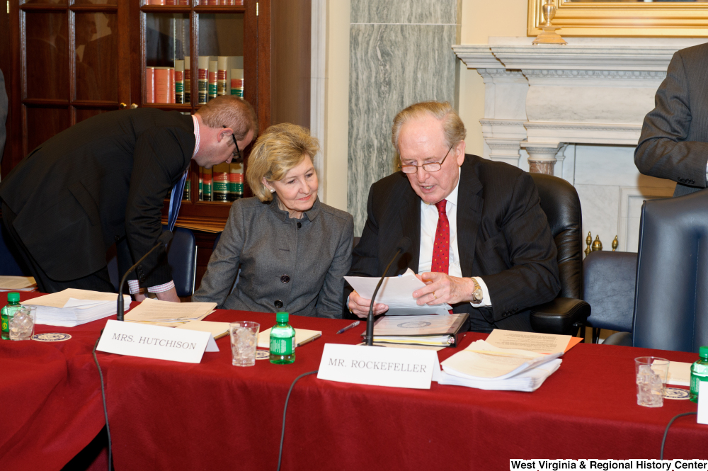 ["Senators John D. (Jay) Rockefeller and Kay Hutchison look at a document before a Commerce Committee hearing."]%
