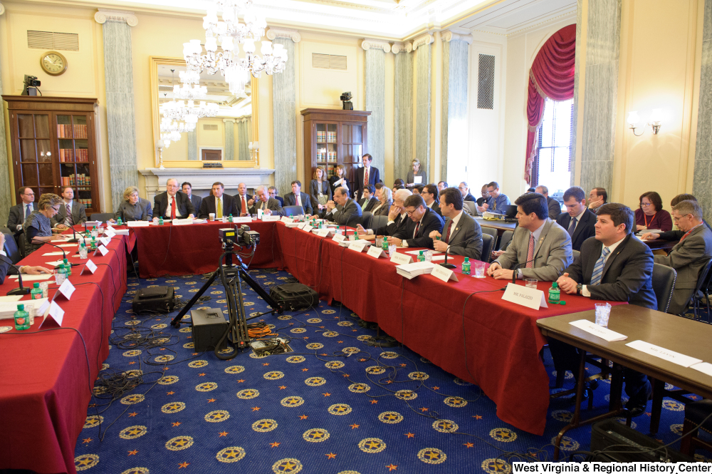 ["Senators and Congressmen gather at a joint session of the Commerce Committee."]%