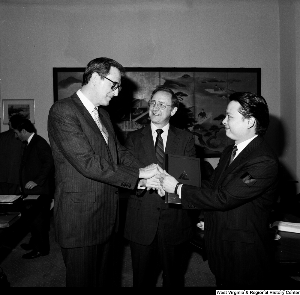 ["Senator John D. (Jay) Rockefeller shakes hands with representative of China Steel in his office."]%