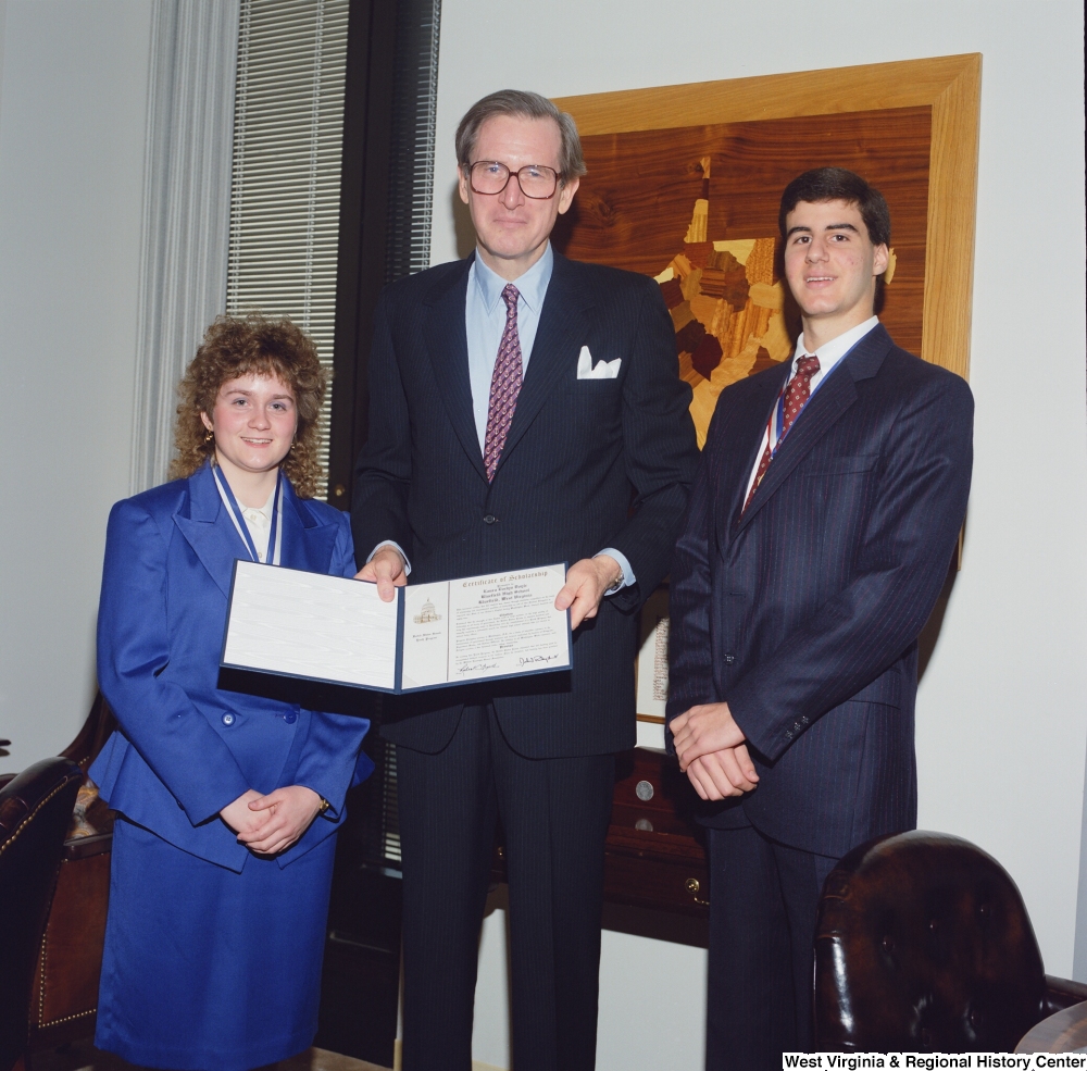 ["Senator John D. (Jay) Rockefeller stands with two United States Senate Youth Program delegates from West Virginia."]%