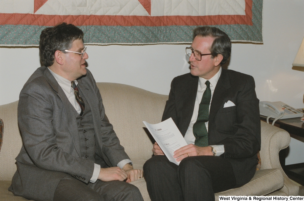 ["Senator John D. (Jay) Rockefeller sitting with a man and holding a copy of the Medicare Physician Payment Reform Act of 1989."]%