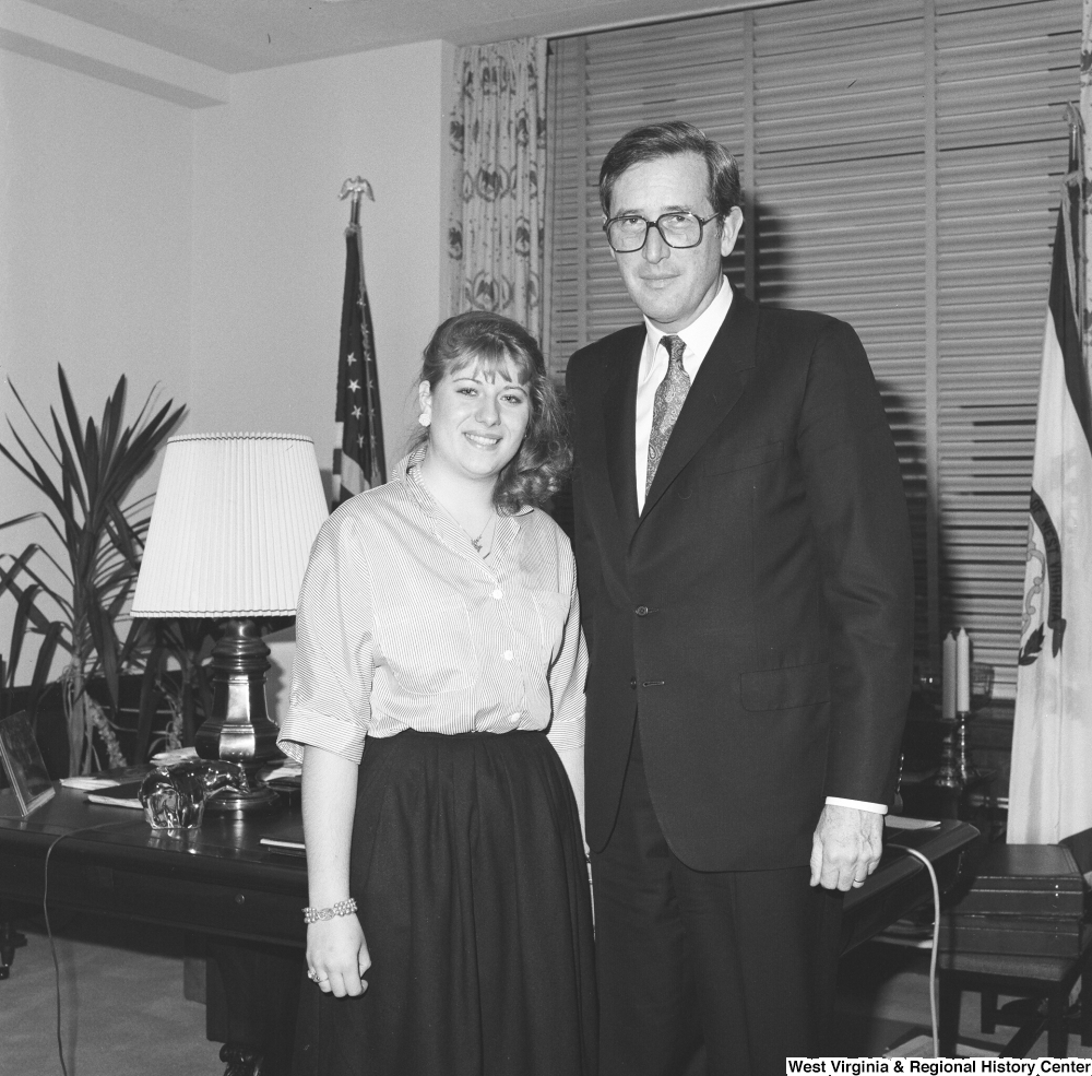 ["Senator John D. (Jay) Rockefeller stands for a photograph in his office with one of his interns."]%