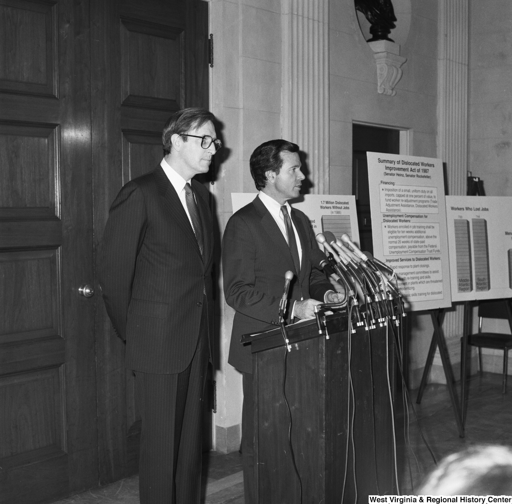 ["Senator John D. (Jay) Rockefeller stands next to Senator H. John Heinz III as he speaks at a press event in support of their piece of legislation, the Dislocated Workers Improvement Act of 1987."]%