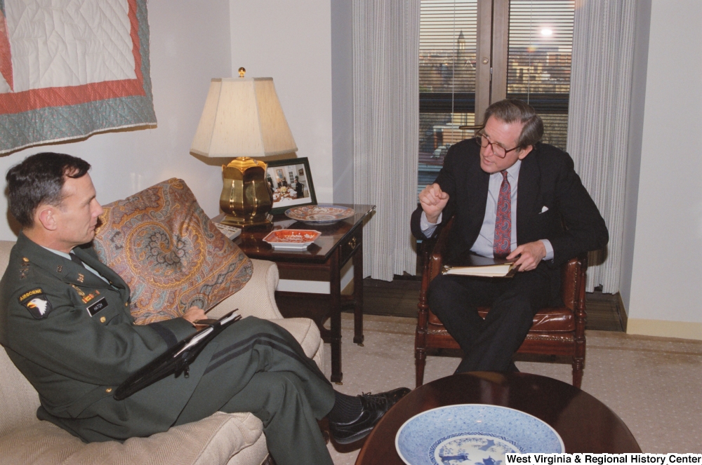 ["Senator John D. (Jay) Rockefeller sits in his office and speaks with General Hatch of the Army Corps of Engineers."]%