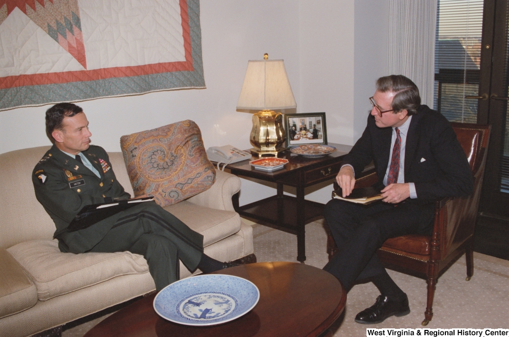 ["Senator John D. (Jay) Rockefeller listens to General Hatch of the Army Corps of Engineers."]%