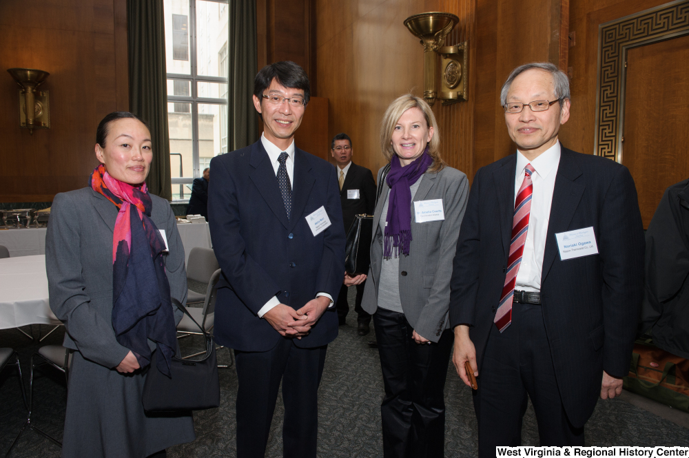 ["Four individuals stand together at a Welcome to Washington luncheon."]%