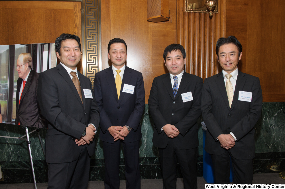 ["Four industry leaders stand together for a photo at a Welcome to Washington luncheon."]%