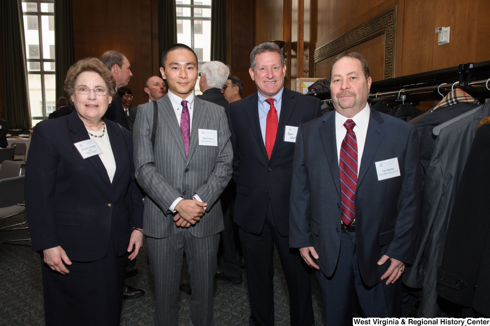 ["Four industry leaders stand together for a photo at a Welcome to Washington luncheon event."]%