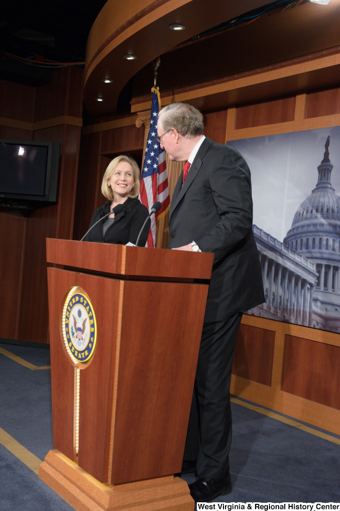 ["Senator John D. (Jay) Rockefeller stands at a podium at a Senate press event."]%