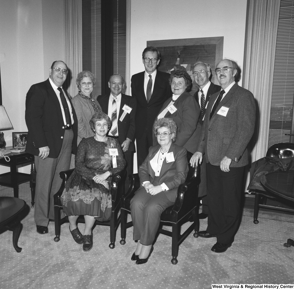 ["Senator John D. (Jay) Rockefeller stands with a group of unidentified individuals in his office."]%