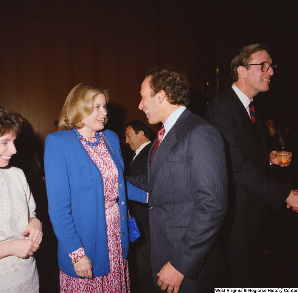 ["Sharon Rockefeller speaks with one of her husband's staffers at a banquet event in the Senate."]%