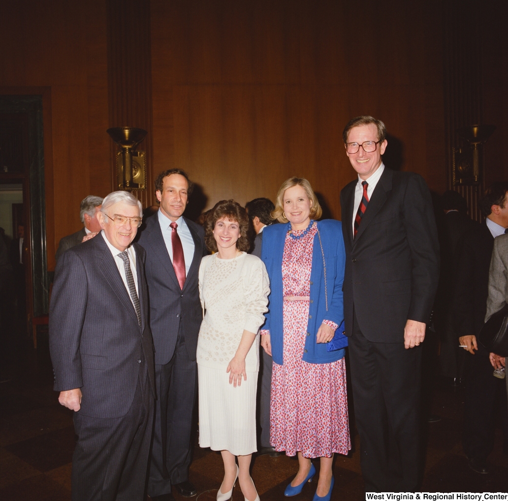 ["Senator John D. (Jay) Rockefeller and Sharon Rockefeller stand for a photograph with several unidentified individuals at an event at the Senate."]%