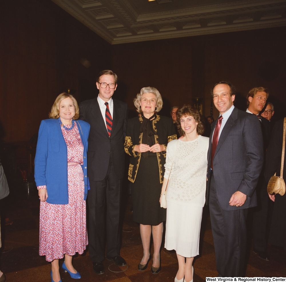 ["Senator John D. (Jay) Rockefeller stands with Sharon and members of his staff at a banquet event in the Senate."]%
