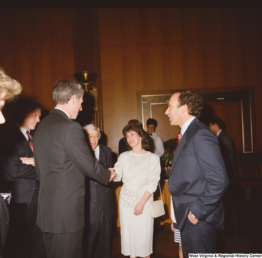 ["One of Senator John D. (Jay) Rockefeller's staff members speaks with guests at an event in the Senate."]%