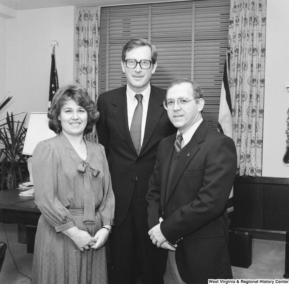 ["Senator John D. (Jay) Rockefeller stands for a photograph with the West Virginia \"Engineer of the Year\" and his wife."]%