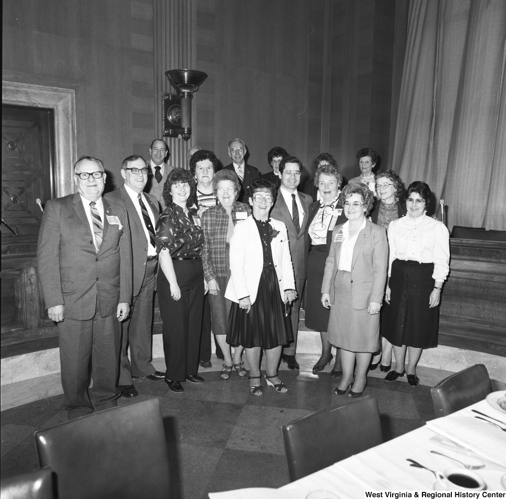["Unidentified members of the National Association of Postmasters of the United States gather for a photograph during an event at the Senate."]%
