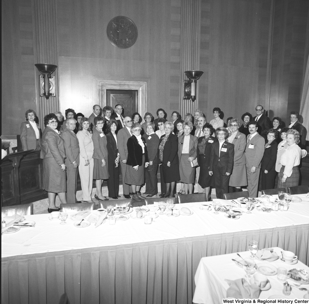 ["Unidentified members of the National Association of Postmasters of the United States gather for a photograph during an event at the Senate. (This photo is from a wider angle and includes all members present.)"]%