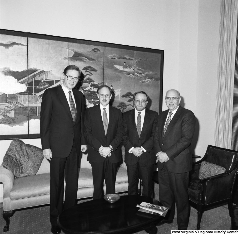 ["Senator John D. (Jay) Rockefeller stands for a photograph with two representatives from University Health Associates and the Dean of the WVU School of Medicine."]%