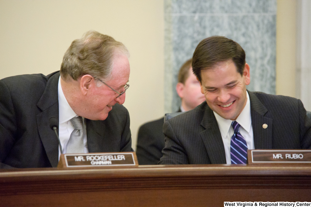 ["Senators John D. (Jay) Rockefeller and Marco Rubio laugh together at a Commerce Committee hearing."]%