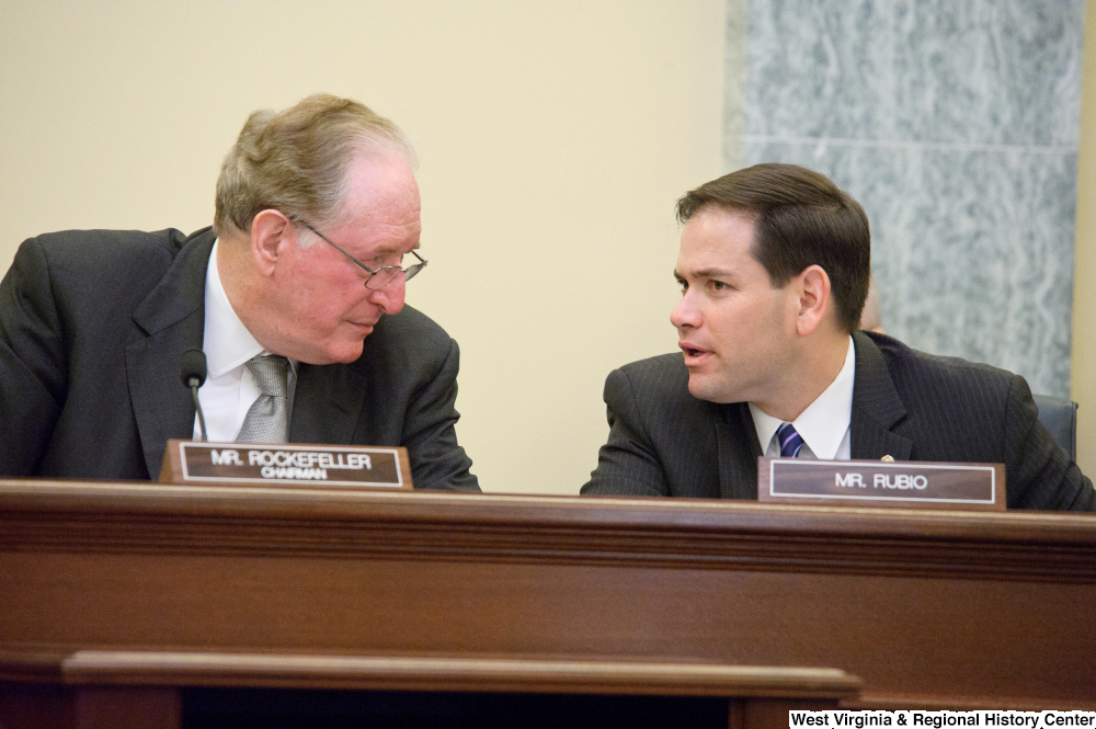 ["Senators John D. (Jay) Rockefeller and Marco Rubio talk during a Commerce Committee hearing."]%
