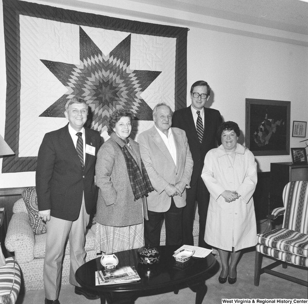 ["Senator John D. (Jay) Rockefeller poses for a photograph with four unidentified individuals in his Washington office."]%