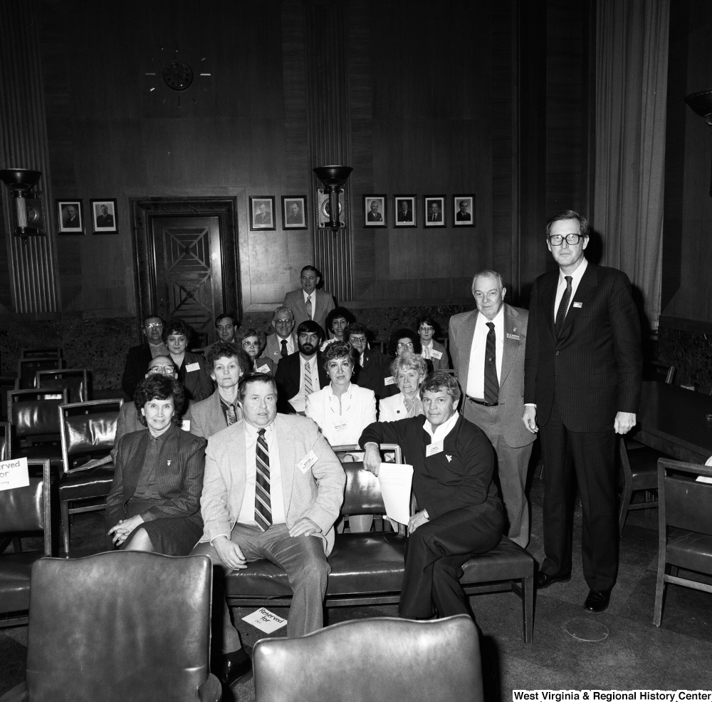 ["West Virginia representatives from the National League of Postmasters sit for a photograph with Senator John D. (Jay) Rockefeller in a Senate office building."]%