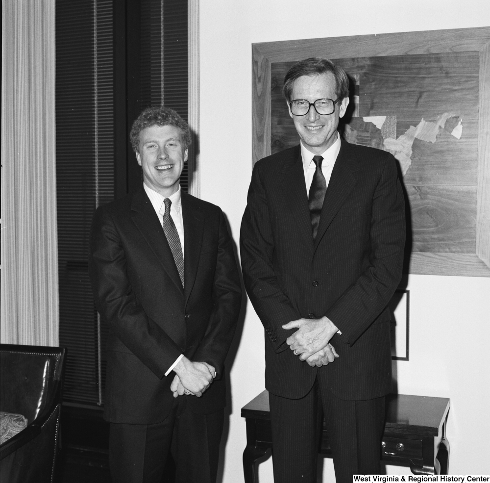 ["Senator John D. (Jay) Rockefeller stands next to an unidentified man in his office."]%