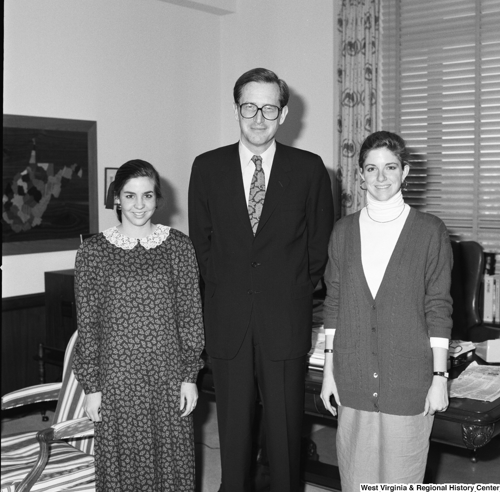 ["Senator John D. (Jay) Rockefeller stands between two unidentified young women in his Washington office."]%