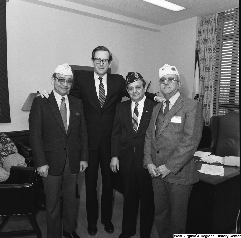 ["Three unidentified members of the American Legion pose for a photograph with Senator John D. (Jay) Rockefeller in his Washington office."]%