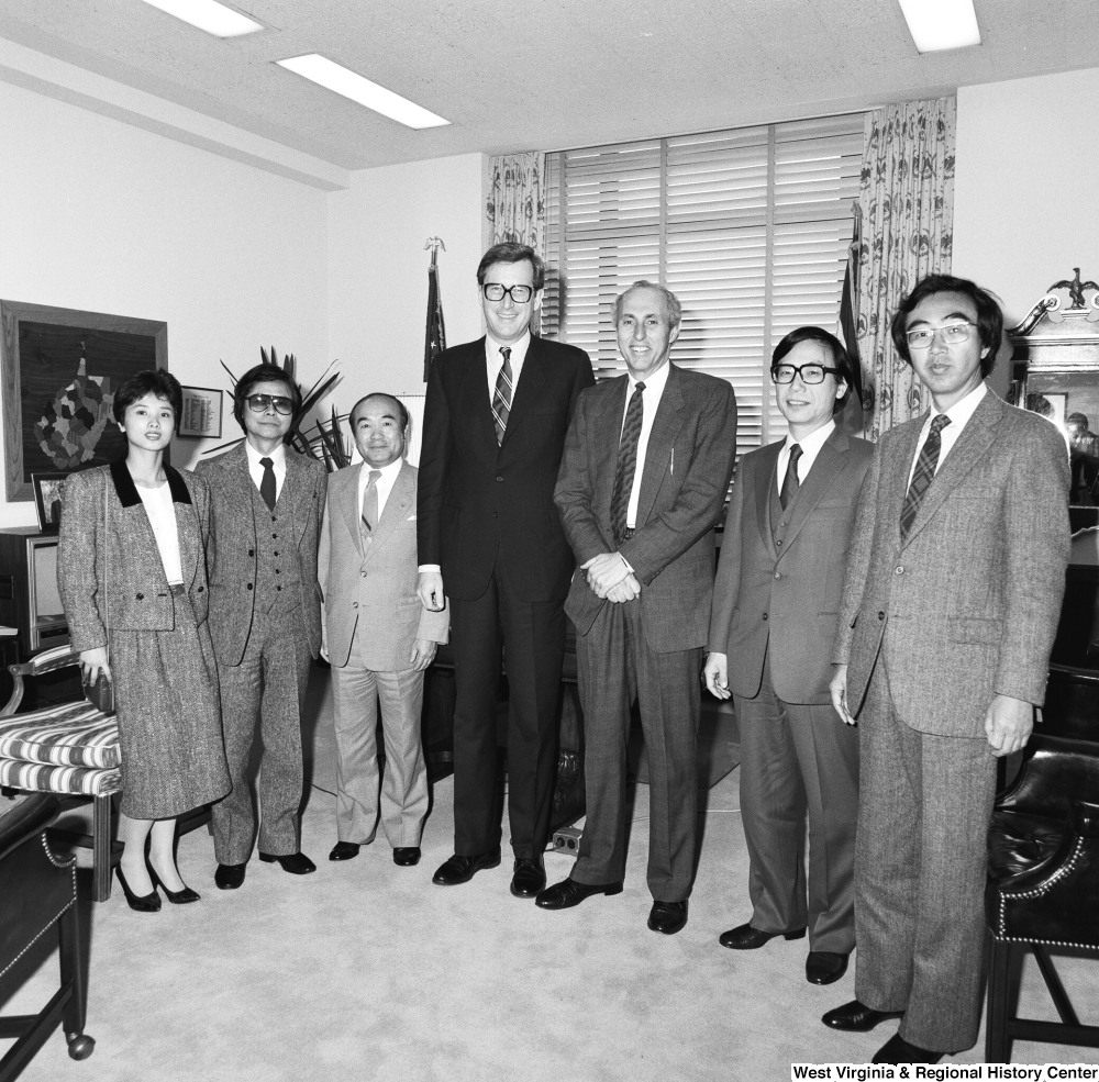 ["Senator John D. (Jay) Rockefeller stands for a photograph with a large unidentified group in his office."]%