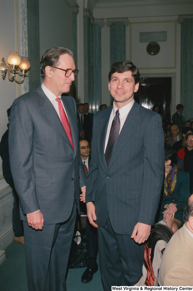 ["Senator John D. (Jay) Rockefeller stands next to a man before an event in the Senate begins."]%