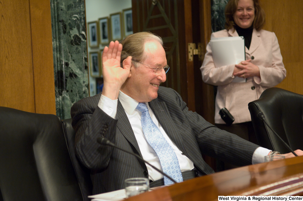 ["Senator John D. (Jay) Rockefeller raises a hand and laughs during a Senate Finance Committee hearing."]%