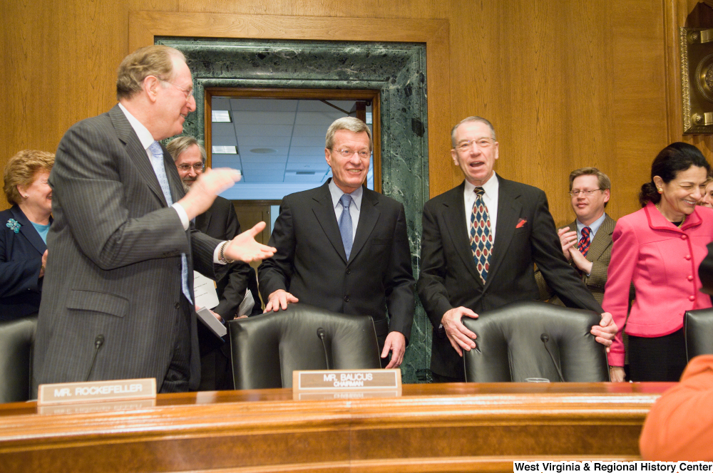 ["Senator John D. (Jay) Rockefeller claps for new Senate Finance Committee chairman, Senator Max Baucus."]%